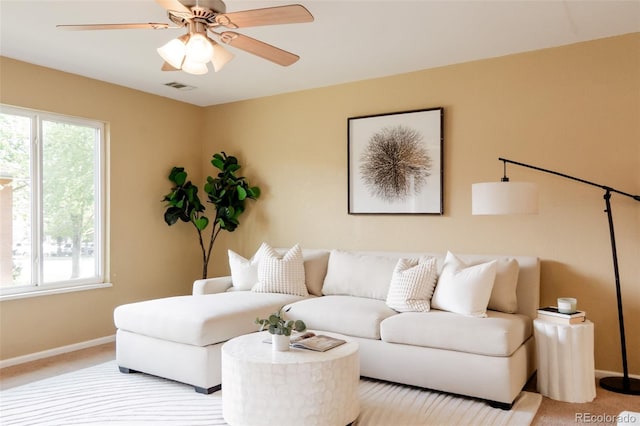 654 S Xenon Ct, Lakewood, CO 80228 - living area featuring plenty of natural light, light carpet, and ceiling fan