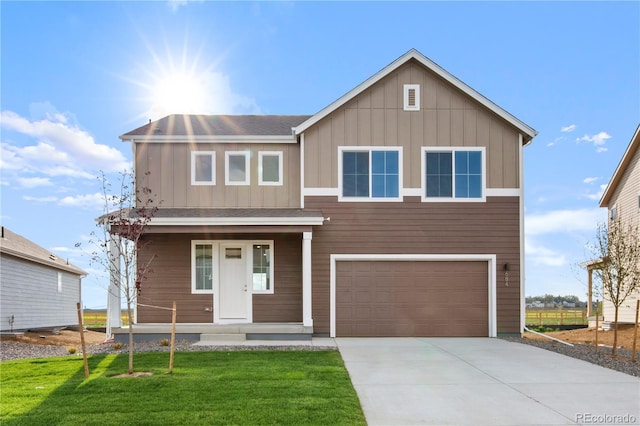 view of front of home featuring a garage and a front lawn