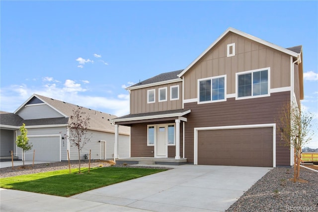 view of front of property with a garage and a front lawn