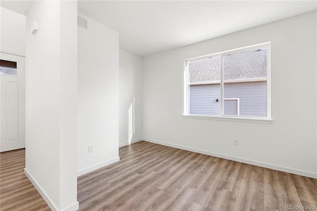 empty room with light hardwood / wood-style flooring