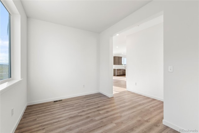 unfurnished room with light hardwood / wood-style flooring