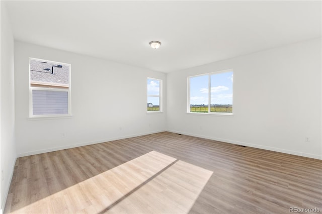 unfurnished room featuring light wood-type flooring