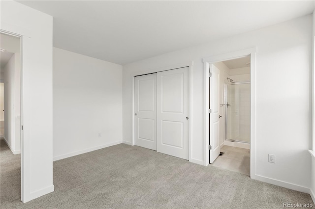 unfurnished bedroom with connected bathroom, a closet, and light colored carpet