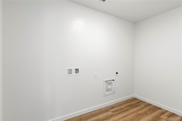 clothes washing area featuring hookup for an electric dryer, hookup for a washing machine, heating unit, and hardwood / wood-style floors