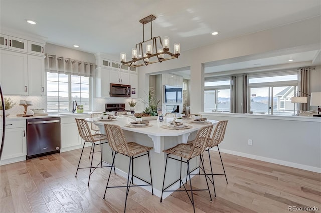 1193 Highview Dr, Erie, CO 80516 - dining area featuring healthy amount of natural light, light wood finished floors, recessed lighting, a chandelier, and baseboards