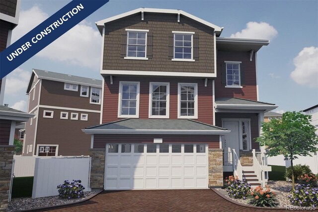 1193 Highview Dr, Erie, CO 80516 - view of front of house with decorative driveway, an attached garage, and stone siding