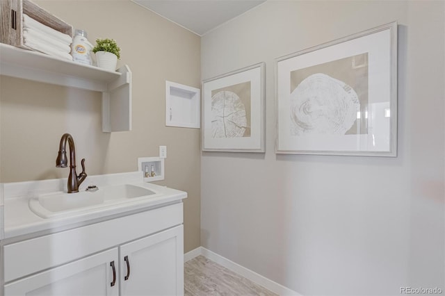1193 Highview Dr, Erie, CO 80516 - laundry area with washer hookup, a sink, baseboards, and light wood-style floors