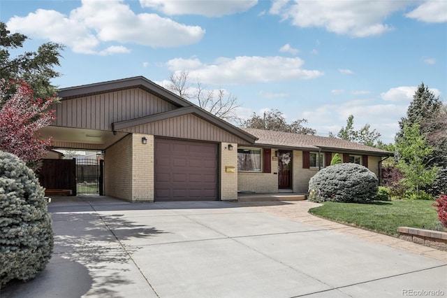 1164 W 101st Pl, Northglenn, CO 80260 - ranch-style home with brick siding, concrete driveway, an attached garage, a gate, and fence