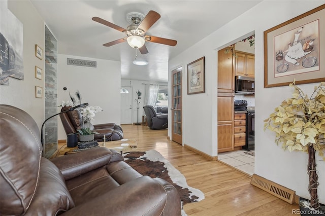 1164 W 101st Pl, Northglenn, CO 80260 - living area featuring ceiling fan and light wood-style floors