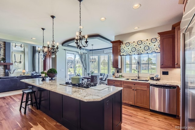 kitchen with stainless steel appliances, a chandelier, healthy amount of natural light, open floor plan, and recessed lighting