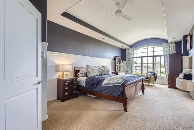 bedroom with light carpet, vaulted ceiling, baseboards, and ceiling fan