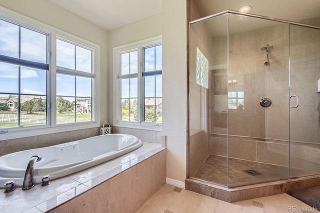 full bath featuring a garden tub, a shower stall, baseboards, and tile patterned flooring