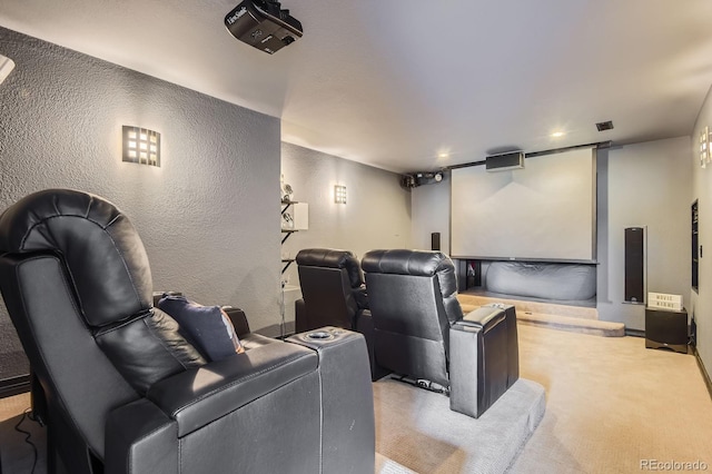 carpeted cinema room featuring a textured wall and recessed lighting