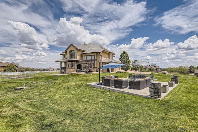 back of house with an outdoor living space and a patio