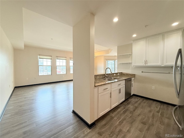 925 N Lincoln St Unit 8H, Denver, CO 80203 - kitchen with stainless steel appliances, open shelves, dark wood-type flooring, white cabinetry, and recessed lighting