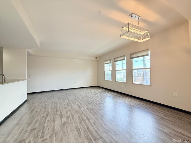 925 N Lincoln St Unit 8H, Denver, CO 80203 - empty room with wood finished floors and baseboards