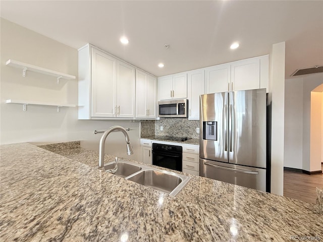 925 N Lincoln St Unit 8H, Denver, CO 80203 - kitchen featuring black appliances, white cabinetry, light stone countertops, open shelves, and tasteful backsplash