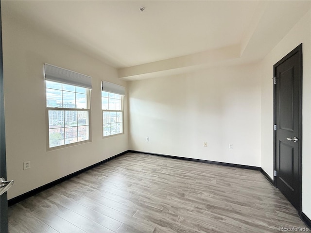 925 N Lincoln St Unit 8H, Denver, CO 80203 - unfurnished room featuring light wood-style flooring and fire sprinkler in ceiling