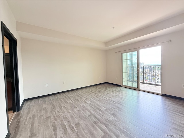 925 N Lincoln St Unit 8H, Denver, CO 80203 - spare room featuring light wood finished floors and baseboards