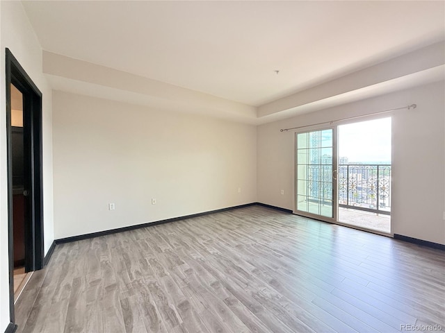 925 N Lincoln St Unit 8H, Denver, CO 80203 - empty room featuring light wood-style floors and baseboards