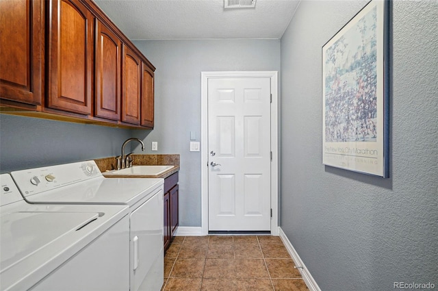 laundry room with tile patterned flooring, washer and dryer, baseboards, a sink, and cabinet space