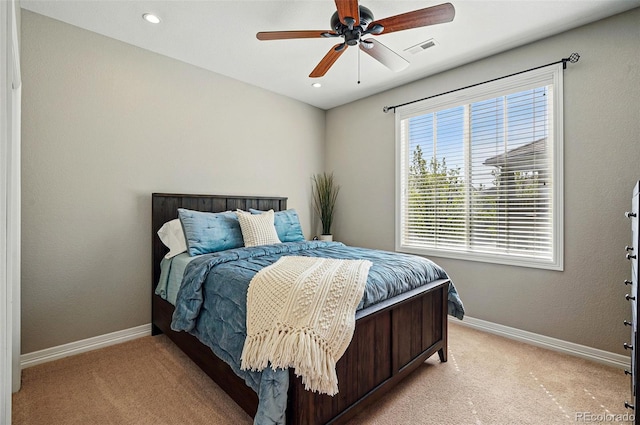 bedroom featuring baseboards, light carpet, recessed lighting, and visible vents