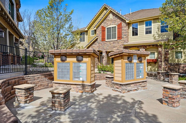 surrounding community featuring fence and mail area