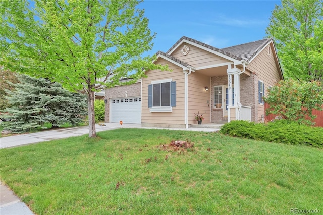 ranch-style home featuring a garage, driveway, a front yard, and brick siding