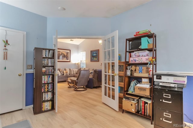 living area with french doors and wood finished floors