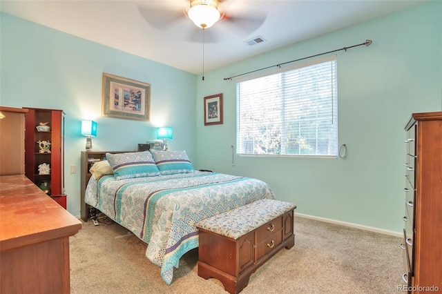 bedroom featuring light colored carpet, ceiling fan, and baseboards