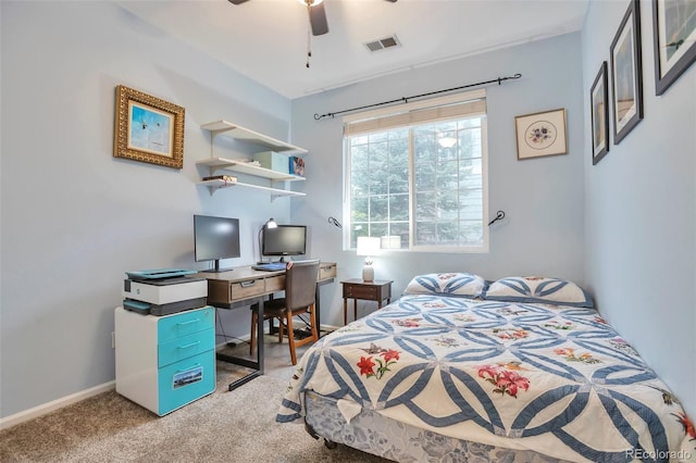 carpeted bedroom with a desk and ceiling fan