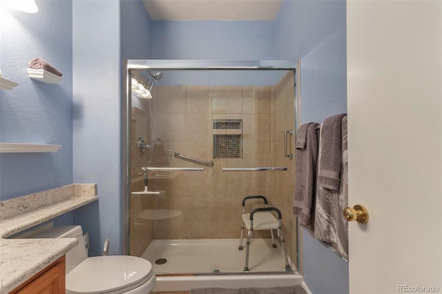 full bath featuring a shower stall, toilet, and vanity