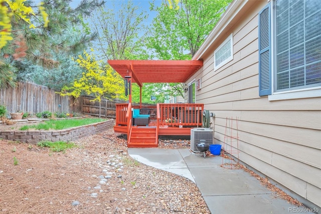 fenced backyard with a deck, a pergola, and central AC