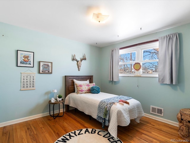 bedroom with wood-type flooring