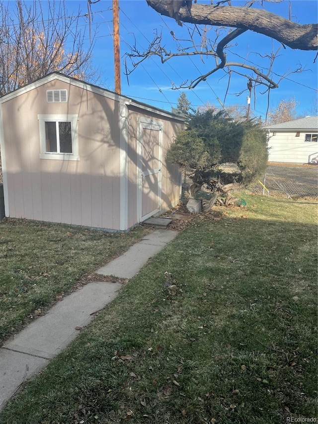 view of home's exterior with a shed and a lawn