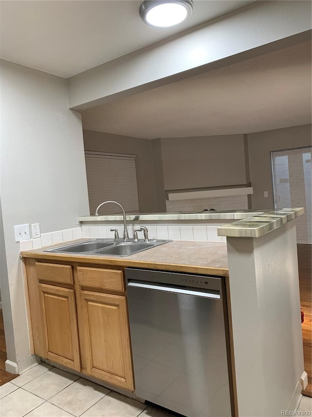 kitchen featuring dishwasher, light tile patterned floors, and sink