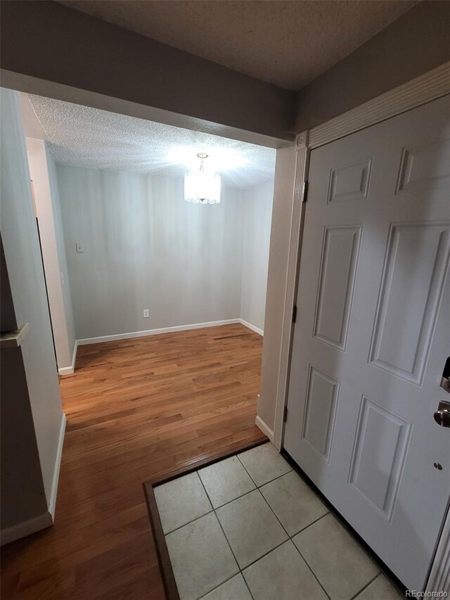 interior space featuring light hardwood / wood-style floors and a textured ceiling