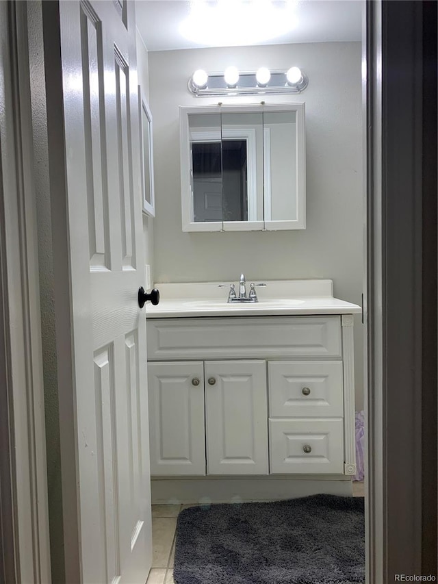 bathroom with tile patterned flooring and vanity