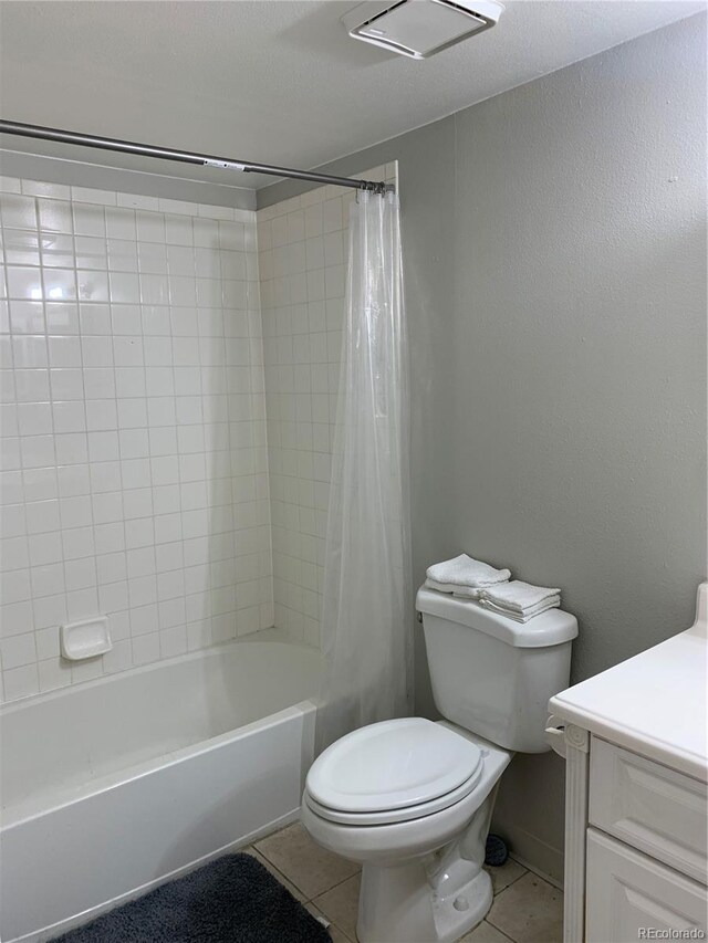 full bathroom featuring vanity, tile patterned floors, toilet, and shower / bath combo