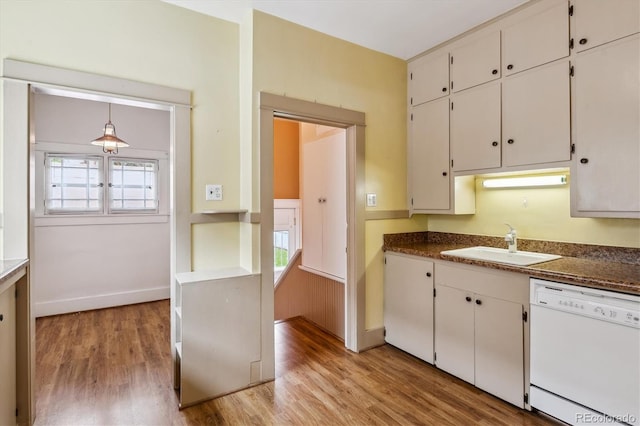 869 S Williams St, Denver, CO 80209 - kitchen with dishwasher, a sink, light wood-style flooring, white cabinetry, and dark countertops
