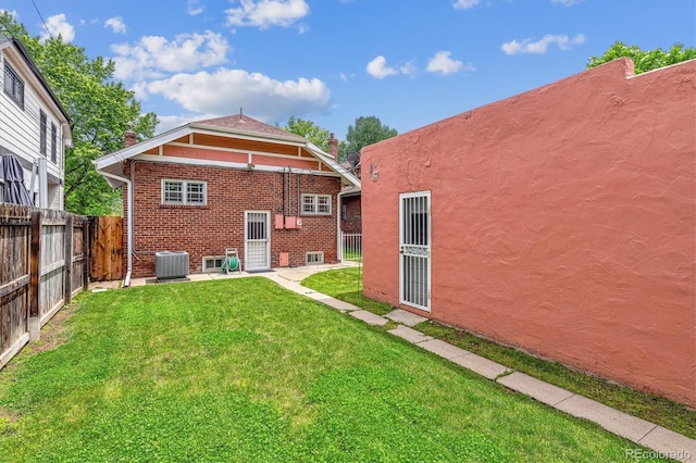 869 S Williams St, Denver, CO 80209 - back of house with central air condition unit, brick siding, a patio, and a chimney