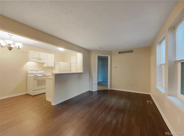 unfurnished living room featuring a textured ceiling, dark hardwood / wood-style floors, and a notable chandelier