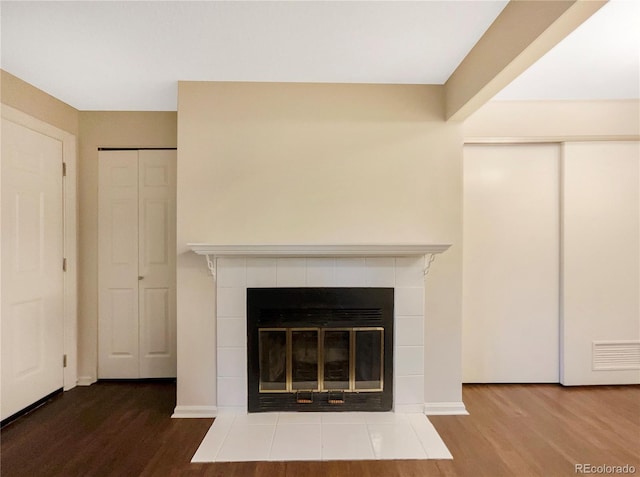 interior details featuring wood-type flooring and a fireplace