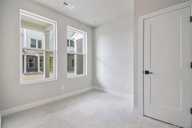 empty room with light colored carpet