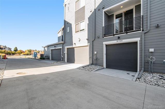 exterior space featuring a garage and a balcony