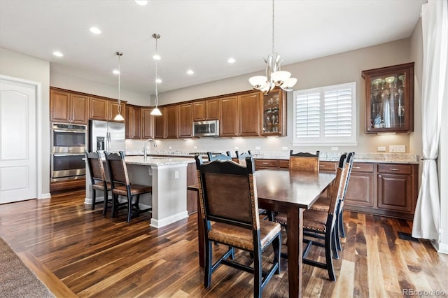 dining area featuring a notable chandelier and dark hardwood / wood-style floors