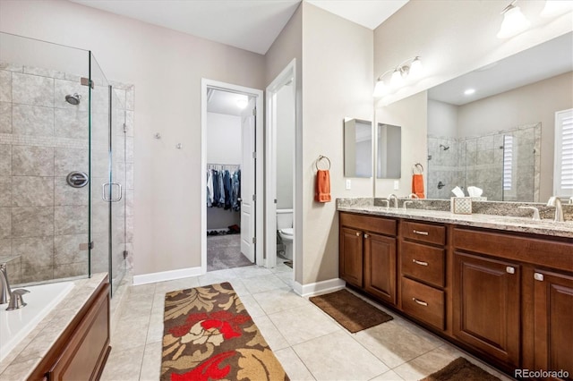 full bathroom featuring toilet, shower with separate bathtub, vanity, and tile patterned floors