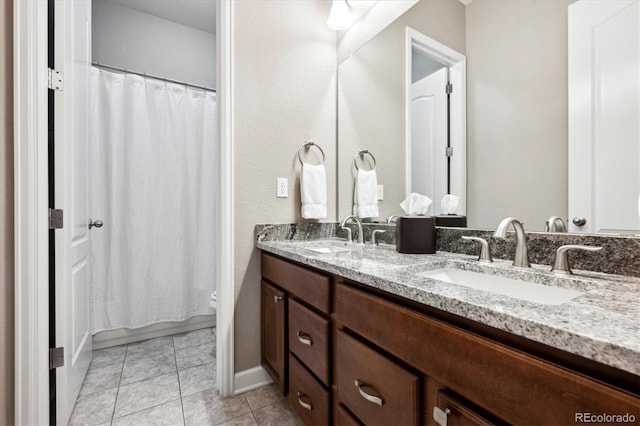 bathroom with tile patterned floors and vanity