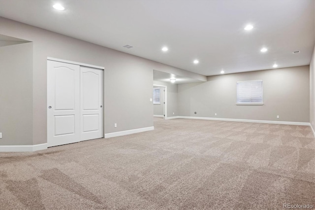 basement featuring light carpet