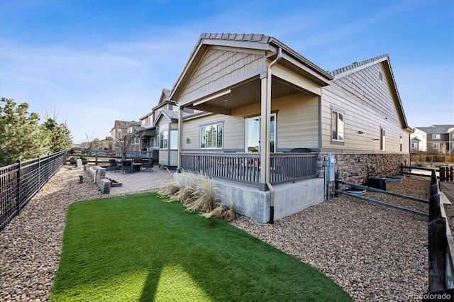 back of property featuring a lawn and a patio area